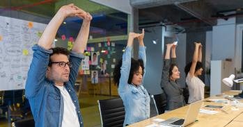 Workers stretching at their desks